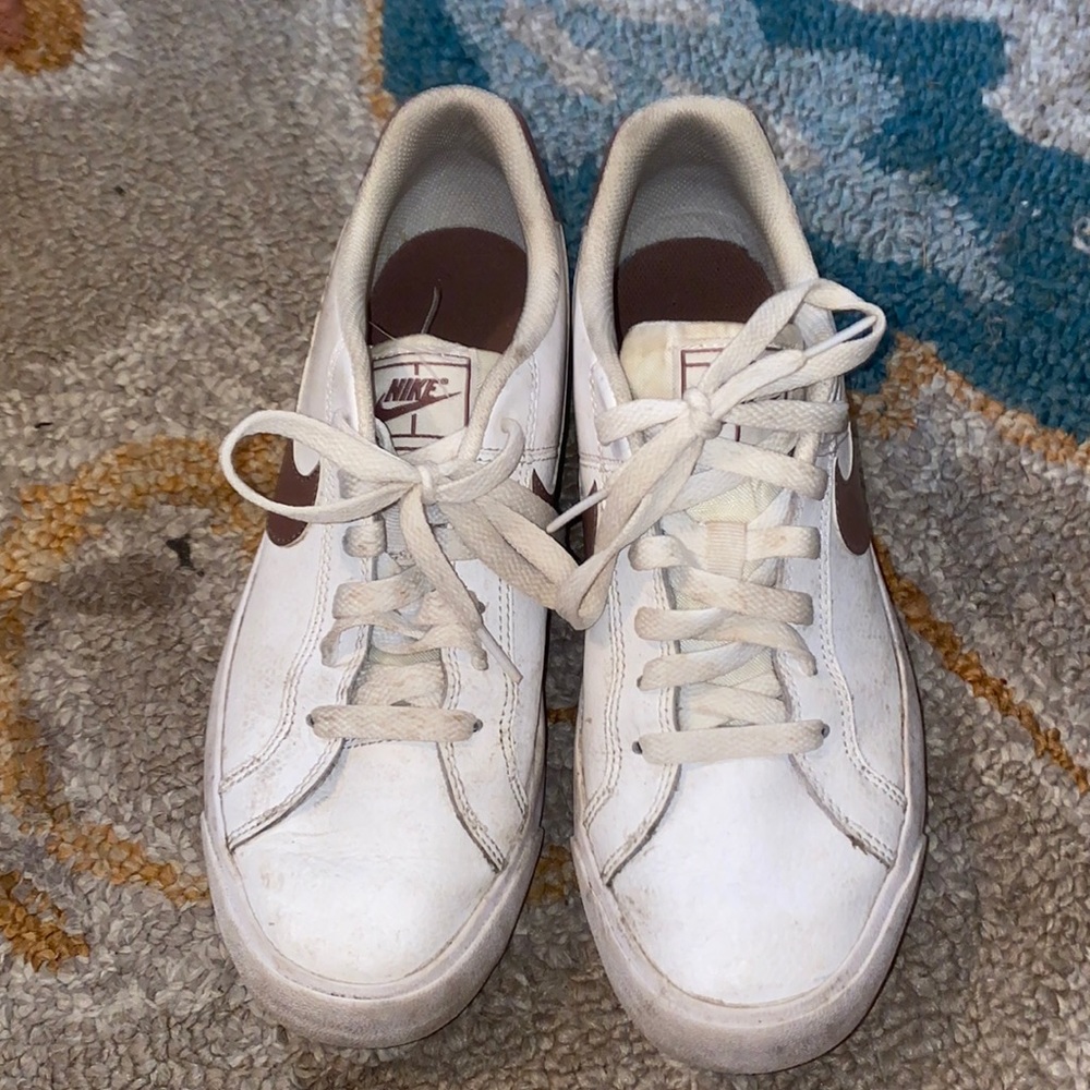 white and pink Nike shoes